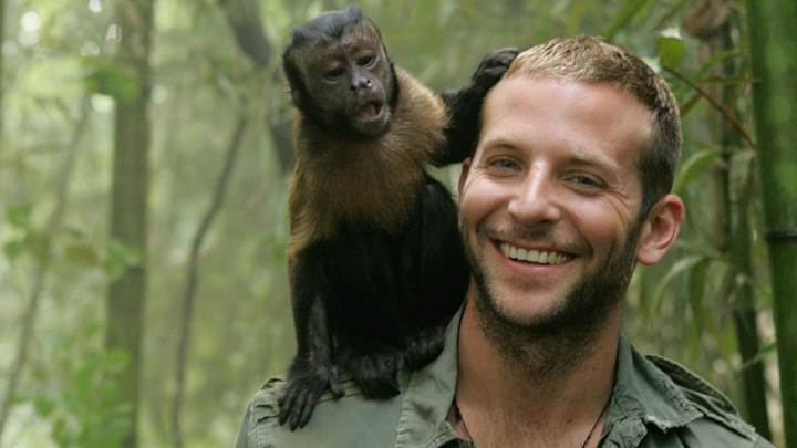 Bradley Cooper Smiling With Monkey On Shoulder In Forest